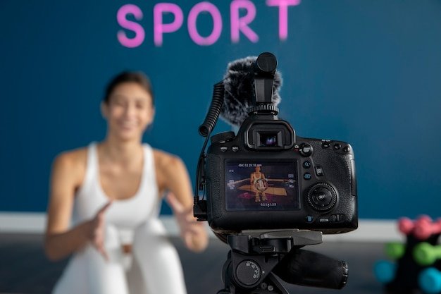 Digital Marketing in Sports: Transforming the Game Online female fitness instructor teaching class home while using camera tripod 23 2149320150